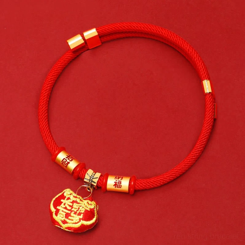 Red adjustable pet collar with gold hardware and longevity-themed pendant charm