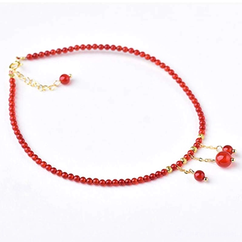 Red agate anklet with adjustable gold clasp and dual dangling pendant design
