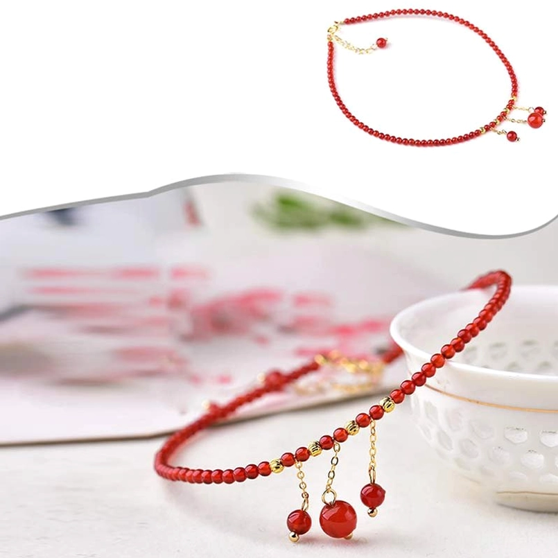 Red agate anklet mixed product display with gold chains and dangling red pendants