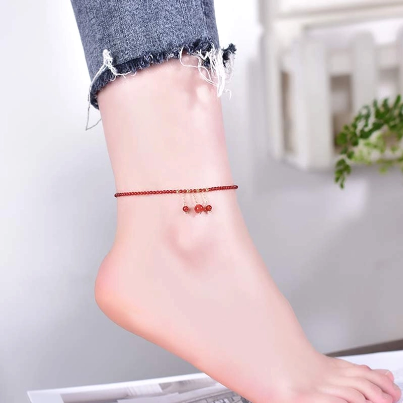 Red agate anklet worn on ankle lifestyle shot showing slim bead chain
