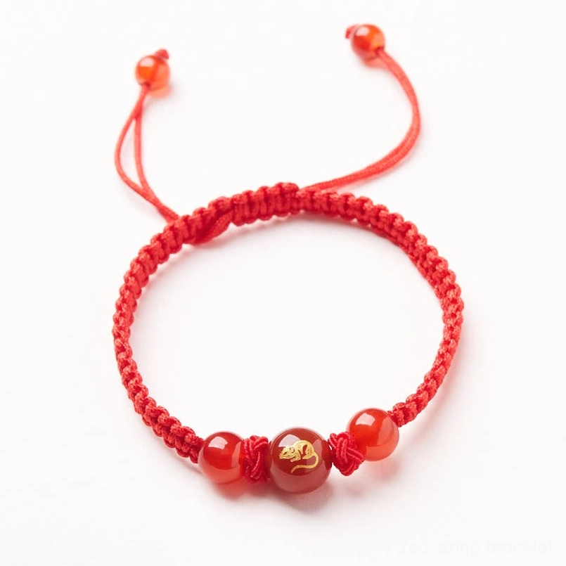 Close-up of red agate zodiac bead with hand-engraved symbol details