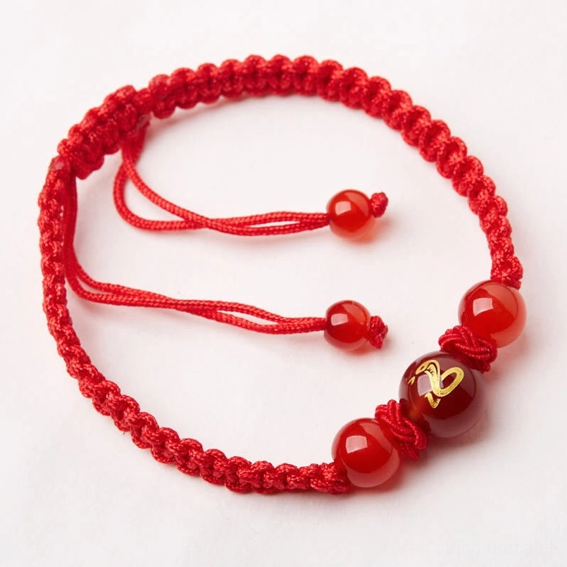 Long red agate zodiac bracelet with dual pull-knots and central engraved symbol