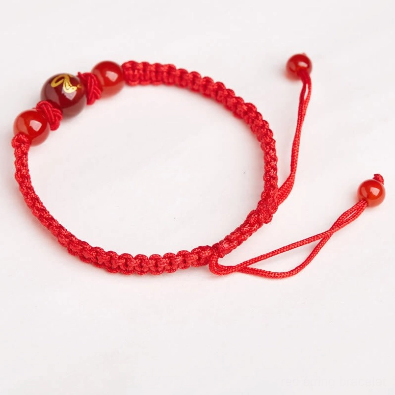 Side view of red string braided zodiac bracelet with adjustable knots