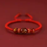 Snake Chinese zodiac red agate bracelet with golden engraving and protective red string