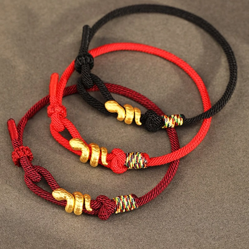 mixed color red black gold snake luck braided bracelets top down view