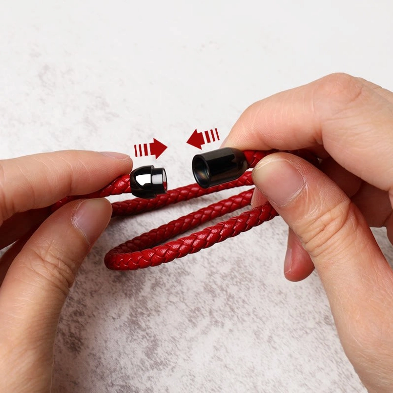 Close-up of magnetic buckle on red leather bracelet demonstrating easy open-close mechanism