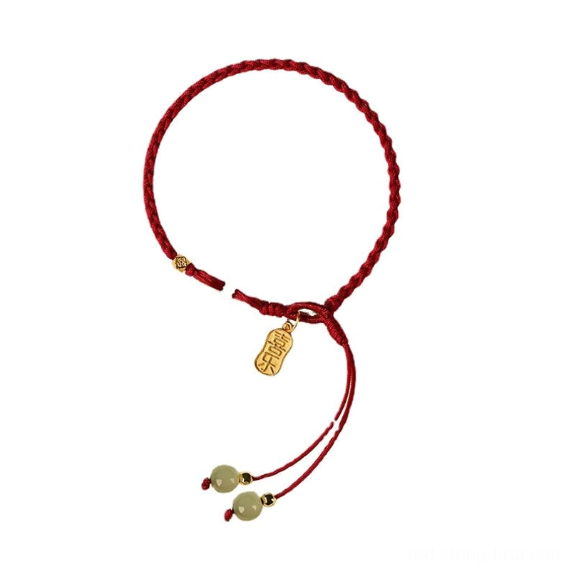 Minimalist red braided string jade bracelet with elongated gold pendant and tassels