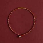 14K gold plated red braided luck bracelet with King Kong knot, top-down flat lay view