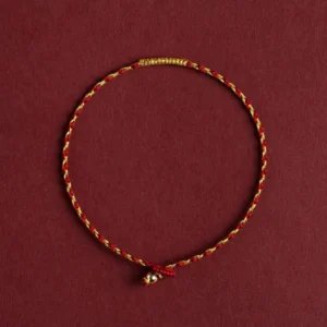 14K gold plated red braided luck bracelet with King Kong knot, top-down flat lay view