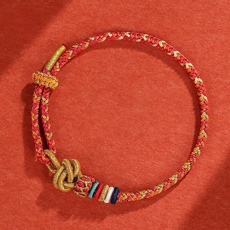 Red colorful handwoven protection bracelet with multicolor threads and golden knot accent