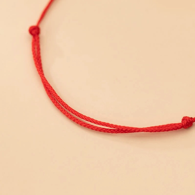 Plain red braided rope protection bracelet with knotted ends