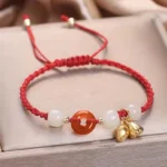 Red braided red string bracelet with red agate peace buckle jade beads and gold lotus pendant