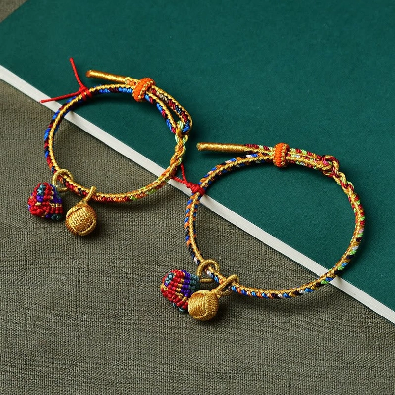 Red colorful five element zongzi golden ball charm red string bracelet close-up