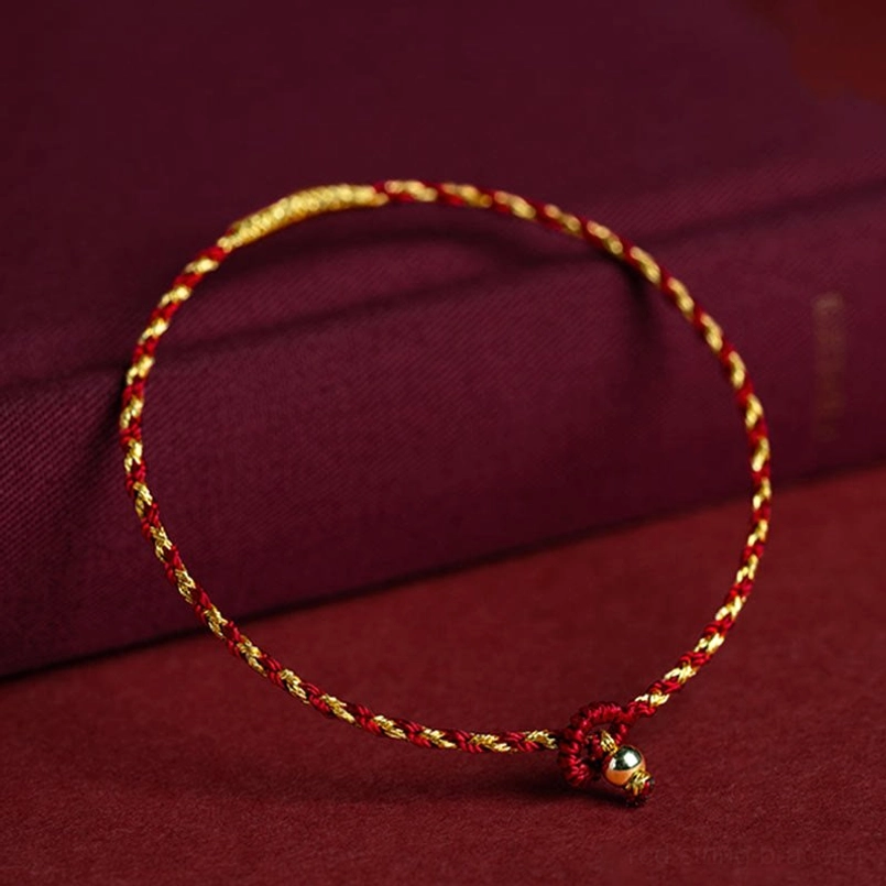 Red and gold twisted cord luck bracelet with King Kong knot closure, three-quarter view