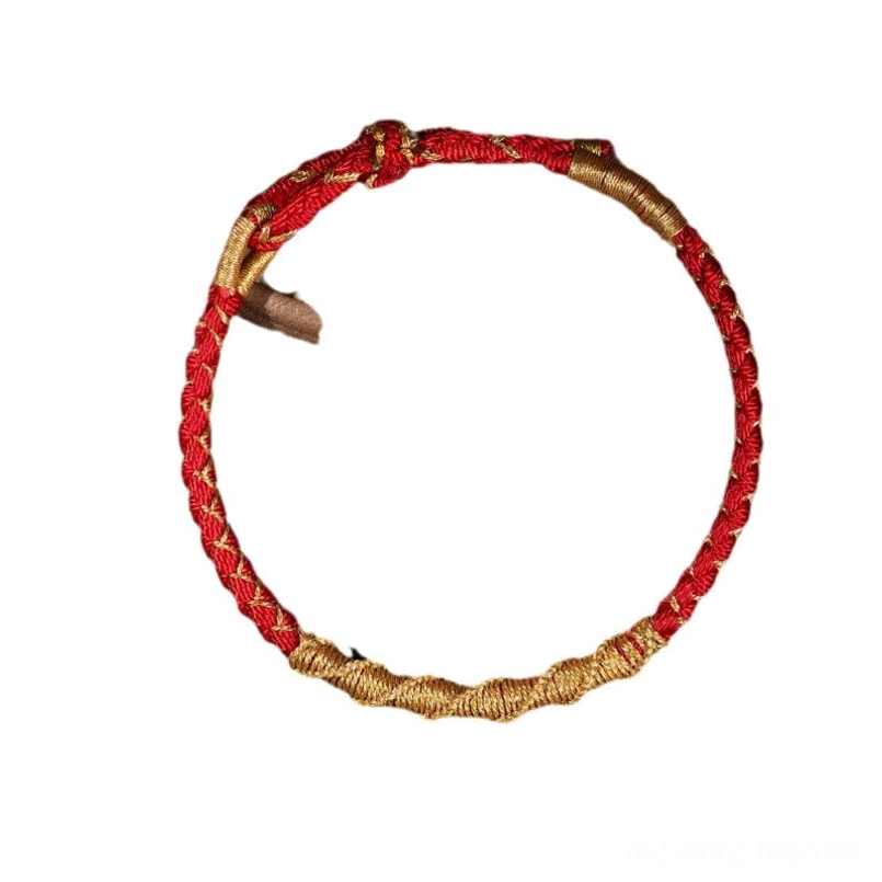 Red string Tibetan woven bracelet with gradient braid and adjustable toggle closure on dark background