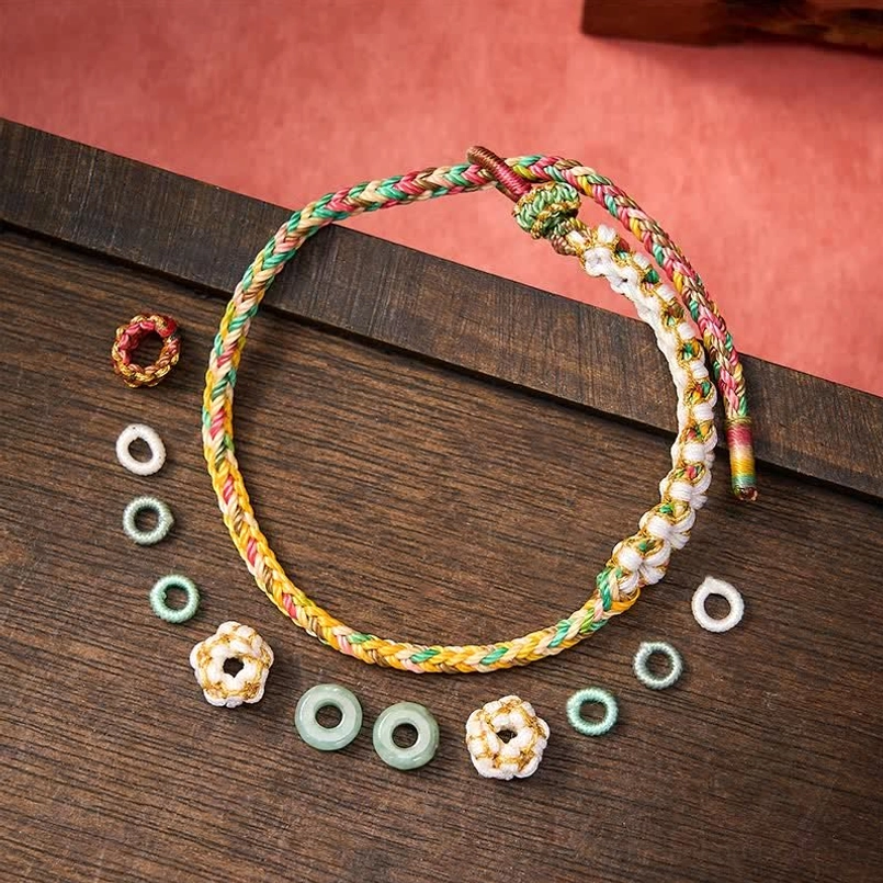 Red string bracelet handmade with traditional Chinese knots and jade