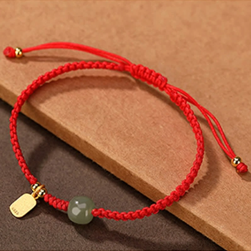 Red braided Hetian jade fortune bracelet with gold fu charm - minimalist design view