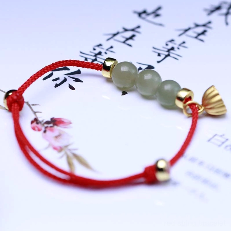 Red woven jade bracelet with lotus seed pod pendant and light green jade beads