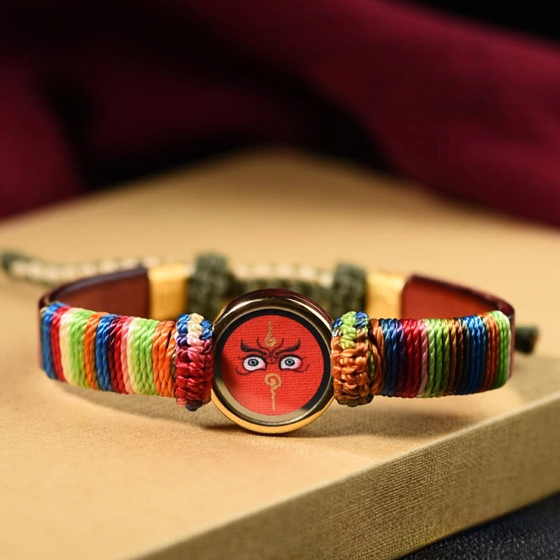 Red Jambhala eye blessing bracelet with colorful woven knots and brown leather band