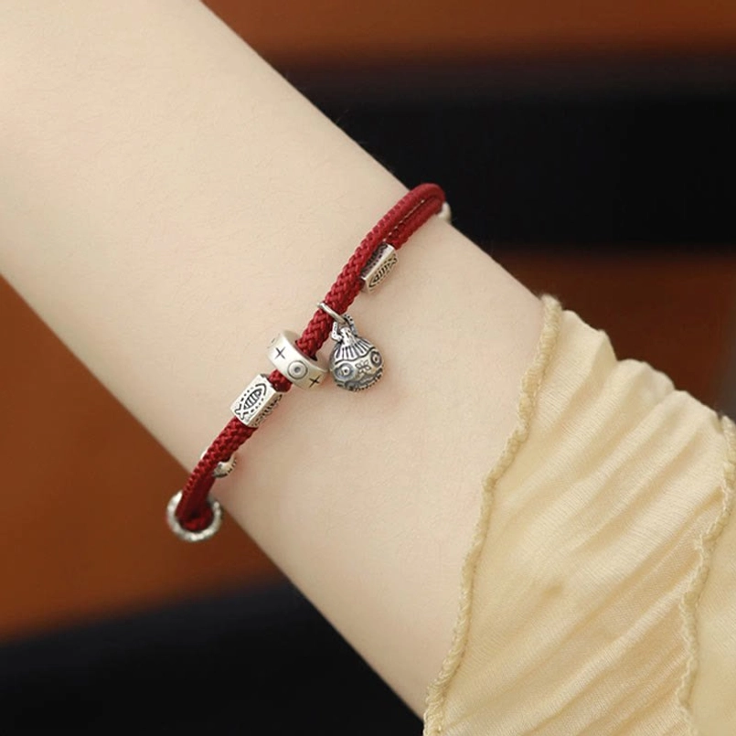 Red braided prosperity bracelet with adjustable silver clasp detail