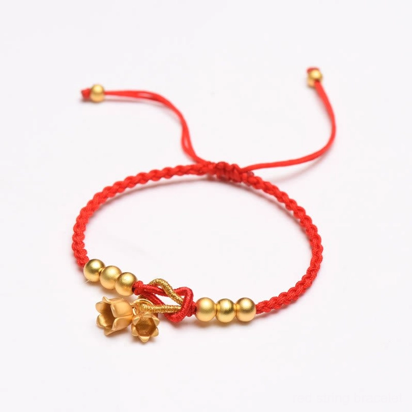Red braided lucky string bracelet with adjustable pull cord and gold lily pendant