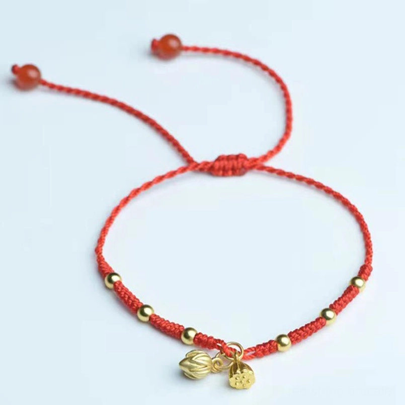 Red woven lotus anklet with sliding knot agate beads and dual lotus charms on white background