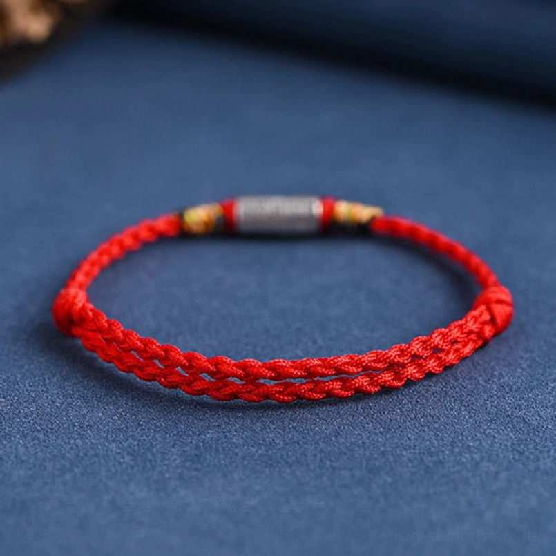 Red woven cotton lucky bracelet with engraved sterling silver charm side view
