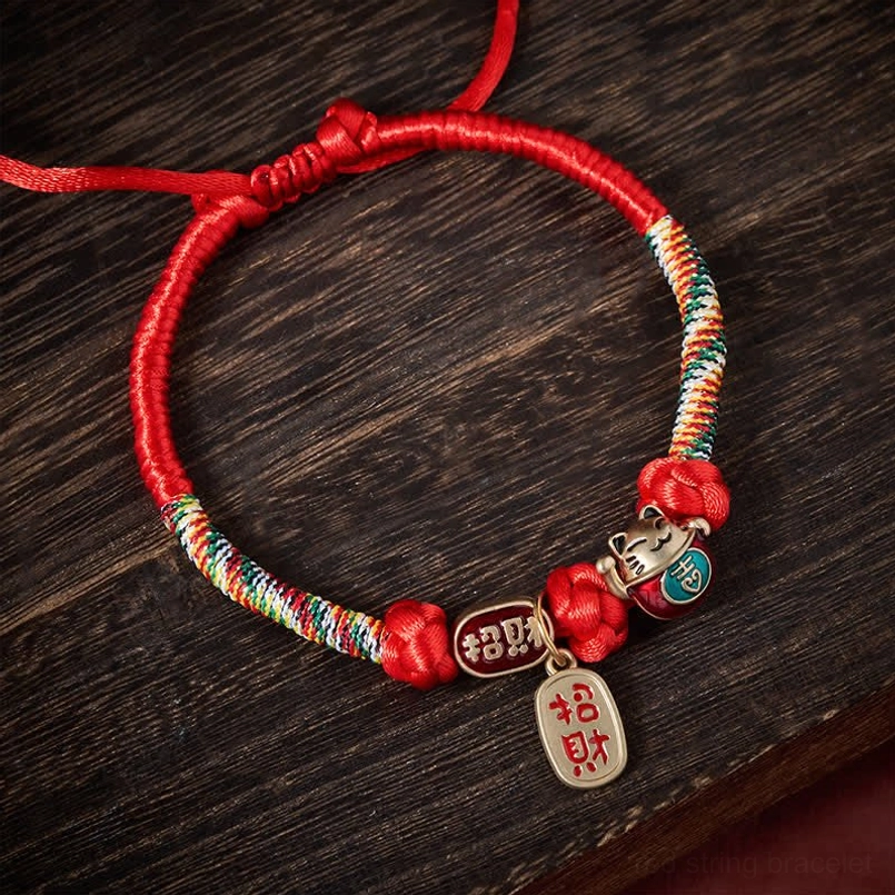 Red plaited pet collar with adjustable pull knot and multicolor braided rope detail