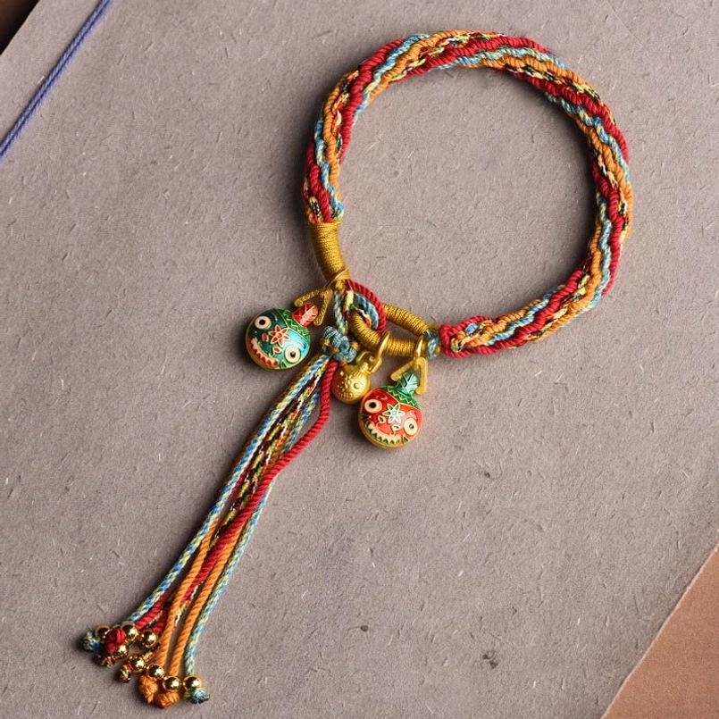 Single red colorful pixiu reincarnation knot bracelet with gold metal hardware and decorative tassel