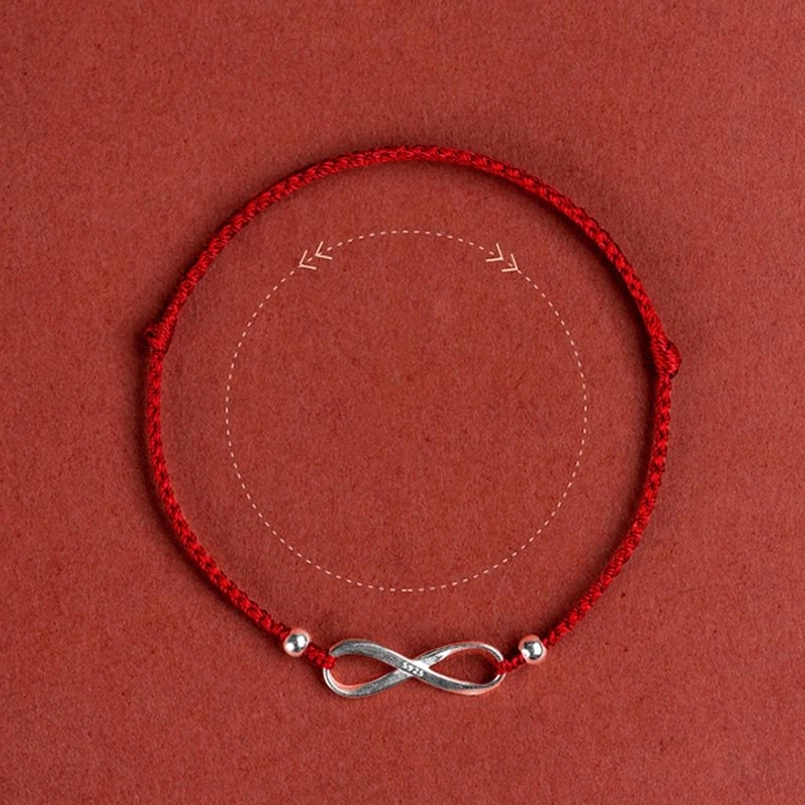 Red protective string bracelet with infinity knot charm lifestyle
