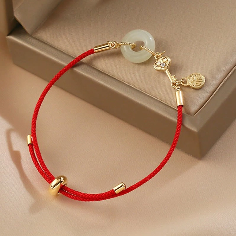 Red rope charm bracelet featuring Fu pendant jade peace buckle and zircon accents