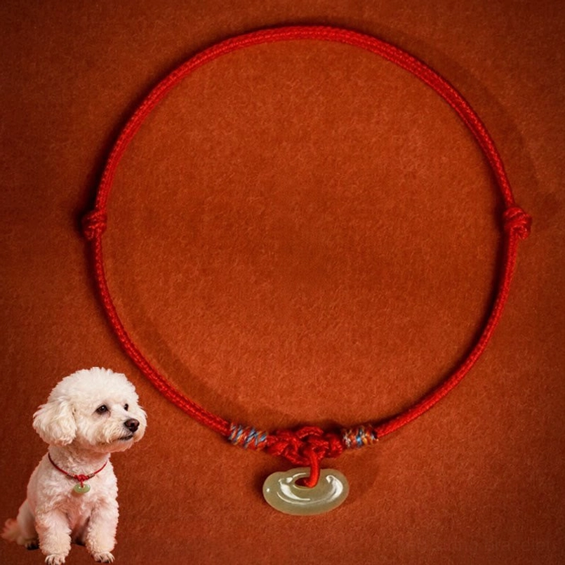 Adjustable red rope pet collar with colorful woven knots and jade pendant, flat lay display