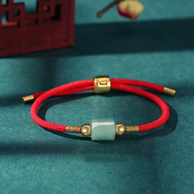 Single red rope Tibetan protection bracelet with cylindrical green aventurine bead and copper gold adjuster