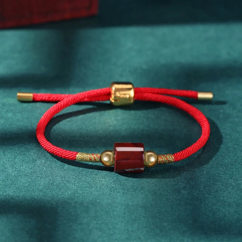 Red stone Tibetan protection bracelet with red braided rope and gold sliding adjuster