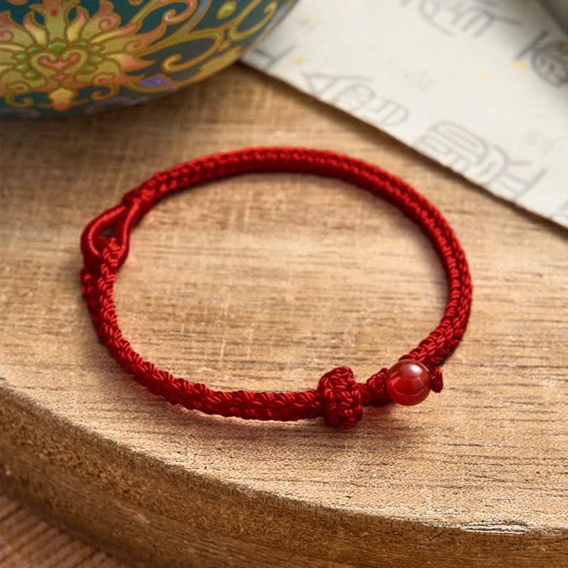 Red string balance bracelet gift presentation with elegant packaging