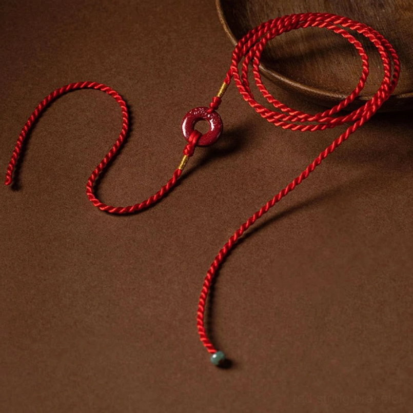 Artistic arrangement of red string belly chain showing flexibility and adjustable length features