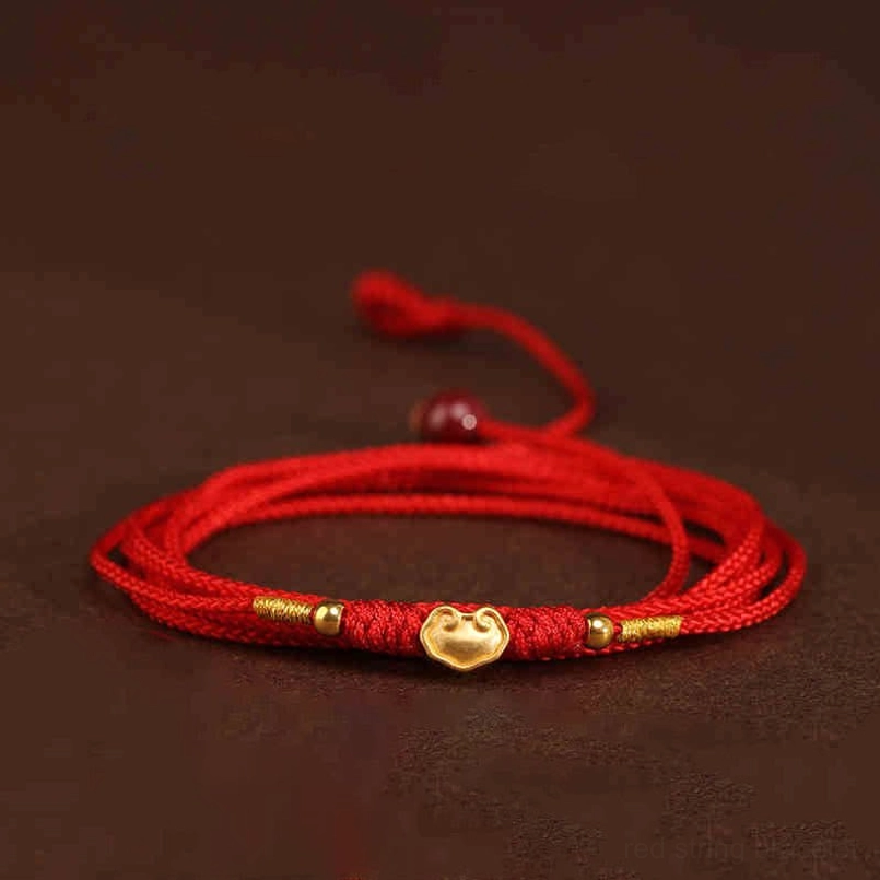 Close-up of red string belly chain worn with transparent or sheer clothing styling option