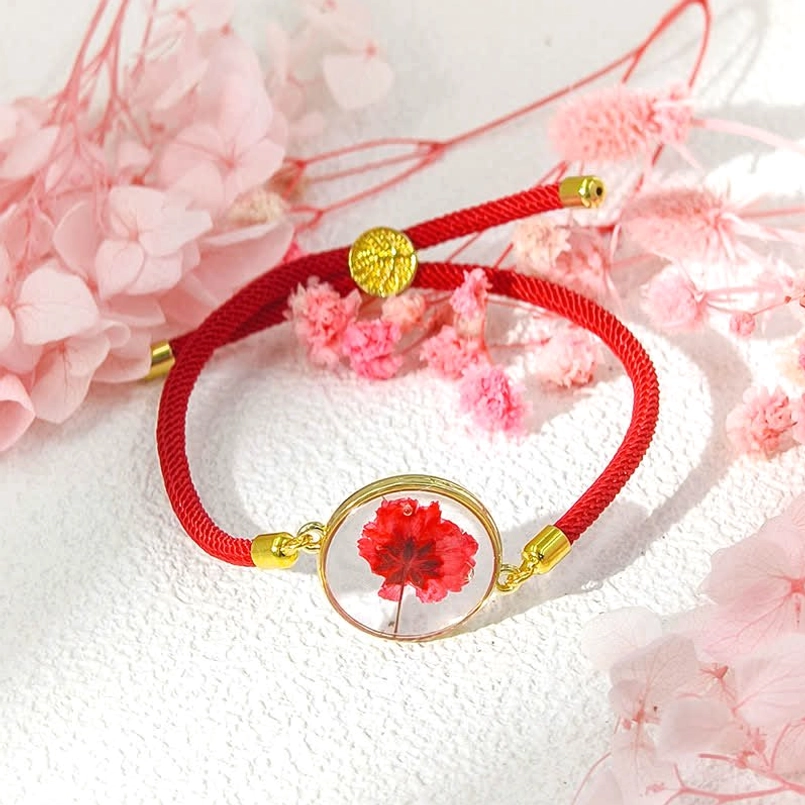 Red braided rope birth flower bracelet with red carnation resin charm and copper hardware