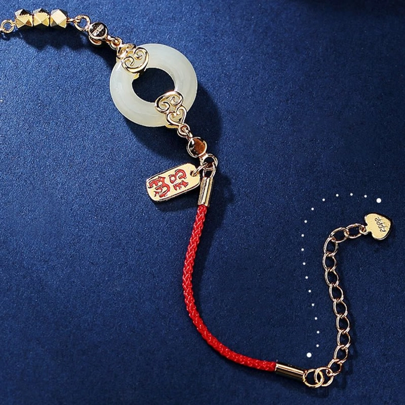 Adjustable red string bracelet with side view showing extension chain and gold-tone clasp