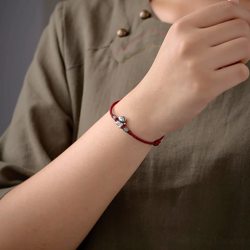 Detail shot of adjustable sliding knot on horse red string bracelet
