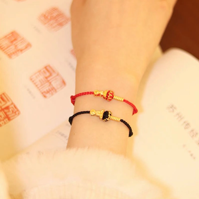 Adjustable red string bracelet with Formless Buddha charm showing knot closure mechanism