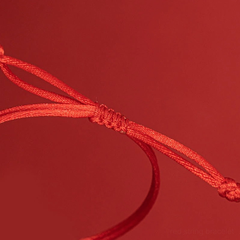 Adjustable braided pull knot detail close up on red string bracelet