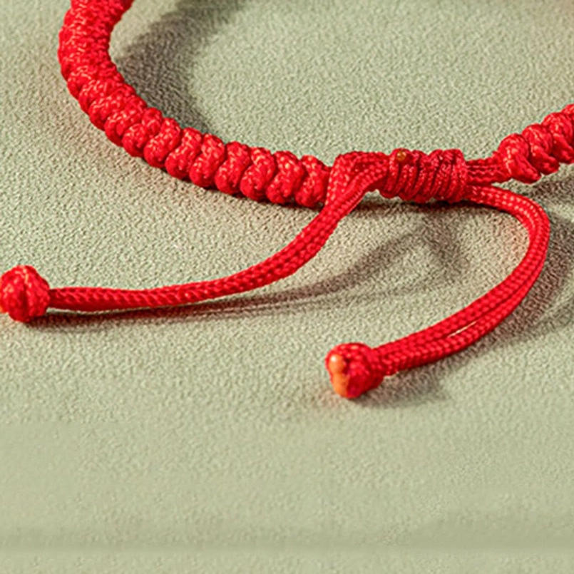 Adjustable sliding knots on premium braided red cord, tight weave close-up