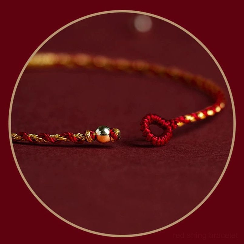 Red string bracelet with adjustable slip-knot closure and King Kong knot amulet charm