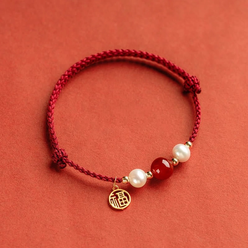 Red agate stone and white pearl beads with gold spacers on adjustable red cord bracelet