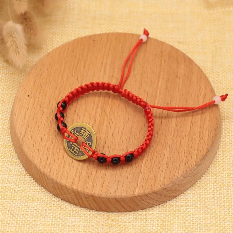 Red string bracelet with black beads and copper coin, fortune protection design