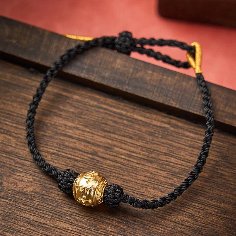 Black red string bracelet variant with gold mantra bead and adjustable cord closure