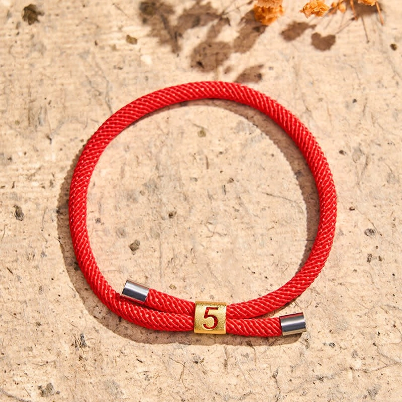 Red string bracelet braided cord texture and craftsmanship detail