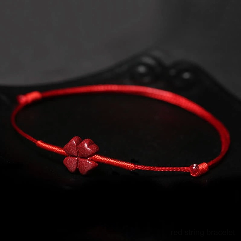 Red string blessing bracelet with charms and wear demonstration inset