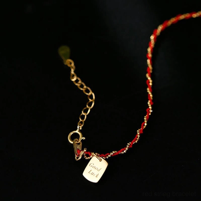Close-up of red string bracelet clasp and sterling silver extension chain with link details